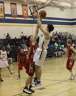 Tonasket senior Wade DeTillian makes a jump shot against Omak during the Tigers’ last home game of the season on Tuesday, Feb. 9. Photo by Terry Mills