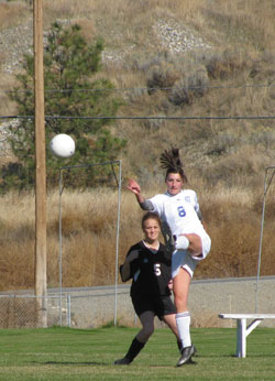 Tonasket junior Ashley Booker boots the ball away from an Omak opponent during Tonasket’s home game on Saturday, Oct. 16. Photo by Emily Hanson