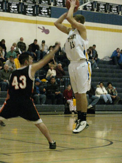 Tonasket senior Brandon Clark makes a jump shot over a Bridgeport defender during the Tigers’ home game against Bridgeport on Tuesday, Dec. 7. Photo by Emily Hanson