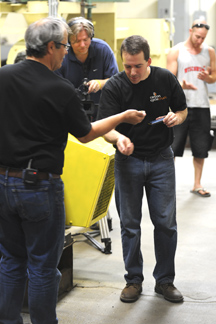 Ryan Skinner, Vice President of Carbon Cycle Crush tastes some of the canola meal produced at the demonstration held at the company's Oroville plant. The meal is highly desired by dairy farmers and poultry farmers for its high C3 Amino Acid content that i