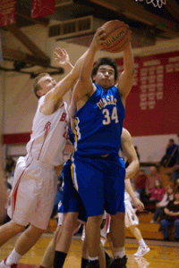 Photo by Brent Baker - The Tigers' Laz Ortega fends off Brewster's Easton Driessen during first round action at the Brewster Christmas Tournament on Thursday, Dec. 29.