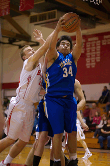 Photo by Brent Baker - The Tigers' Laz Ortega fends off Brewster's Easton Driessen during first round action at the Brewster Christmas Tournament on Thursday, Dec. 29.