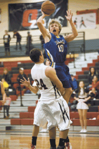 Photo by Brent Baker — John Stedtfeld tries to get to the hoop against Omak on Jan. 17, but picks up a charging call for hits efforts.