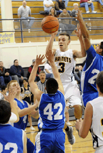 Oroville's CJ Mathews heads skyward for a two-point jumper against the Trojans. Mathews had 12 points against Manson. In the previous match up against the Trojans Mathews had a triple double.