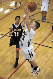 Photo by Brent Baker — Luke Kindred gets past Bridgeport's defense for two of his 10 points during Oroville's rout of the Mustangs last Tuesday.