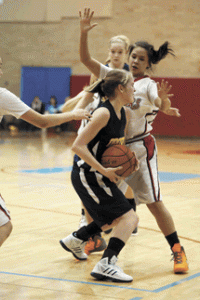 Photo by Brent BakerWhite Swan's physical defense gave Briana Moralez (1) and the Hornets fits early on, but Oroville adjusted to the Cougars' style of play and were only outscored by nine points in the final three quarters of Monday's loss.