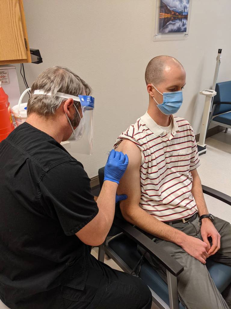 Submitted photo
The day after the <em>G-T</em> interviewed North Valley Hospital District Administrator John McReynolds the district received its first shipment of vaccine. Pictured here is Jeff Massart, a Physical Therapist employed by NVH. As a health care worker he received the Pfizer vaccine to prevent the spread of COVID-19 on Wednesday morning, Dec. 16. The shot is being administered by Michael Oberg, RN.