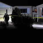 Okanogan County Sheriffs Deputies secure the residence of murder victim Siri Zosel last Saturday evening. Roy Rasmuseen, 70, Okanogan, was booked for first degree murder in what Sheriff Tony Hawley described as a fatal domestic dispute. <em>Gary DeVon/staff photo</em>