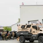 Okanogan County Sheriff s Deputies, the North Central Washington Special Response Team and the East Cascade SWAT Team gather in Tonasket to discuss an attempt to serve a search warrant on a Loomis man Wednesday. The attempt was made after the man, who is prohibited from owning firearms, is alleged to have fired during a dispute with neighbors in the Toats Coulee area.	<em>Laura Knowlton/staff photos</em>