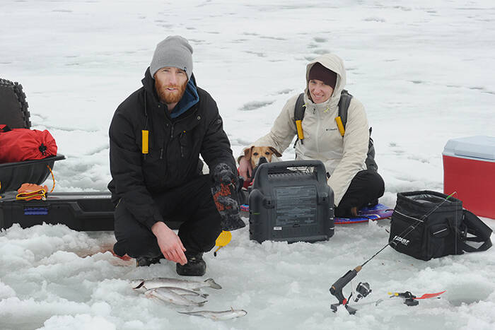 William and Agnes Gutman from North Bend show some of their catch during Saturdays ice fishing festival while their dog Phoenix keeps a watchful eye. So far that morning, his largest catch was a 2.2 pounder.
<ins>Gary DeVon / staff photo</ins>