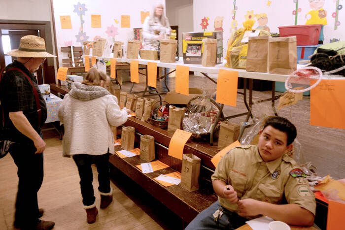 Folks check out the several raffle prizes for the Ice Fishing Festival while Xander Jimenez volenteers at the registration/ticket table. Chamber President Rocky DeVon said several people had positive comments for the Boy Scout who helped out in the Molson Grange Hall during the festival. There were also 13 vendors who set up in the hall.
Gary DeVon/staff photo