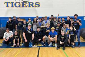 Members of the Tonasket Tigers Wrestling get ready to celebrate their team win following their annual Apple Pie Tournament. Submitted photo