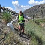 A volunteer helps pick up litter on Hwy. 97 near Crumbacher in a previous years Adopt-A-Highway clean up.