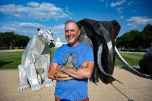 Artist Quill Hyde poses with their exhibit for PETA on the National Mall in Washington, DC. Submitted photos/PETA