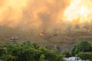 Fire burns along the ridge of a hillside west of Oroville, after traveling three miles from Blue Lake Road last month. The fire eventually burned across the border into Canada.. The state Deptartment of Natural Resources has begun using remotely operated cameras around the state to scan for signs of wildfire and dispatch fire and quickly alert authorities to respond. Gary DeVon/GT File Photo