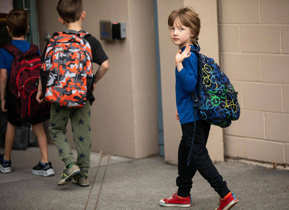 Orion Muller waves goodbye to his mother on Wednesday, Sept. 14, 2022, his first day of kindergarten at Greenwood Elementary. Washington is the only state that doesnt require kids to start school until age 8. (Amanda Snyder/Crosscut)