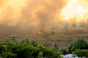 The Eagle Bluff Fire burns along the ridgeline west of Oroville after traveling three miles from Blue Lake Road, as seen from the Oroville Post Office. The fire, which took place in late July, eventually crossed the border into Canada.
<em>Gary DeVon/GT File Photo</em>