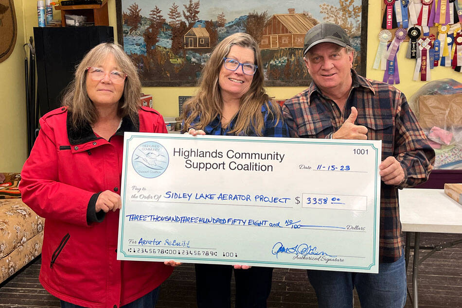 The Highlands Community Support Council (HCSC) donated enough money to rebuild an aerator to replace the one at Sidley Lake. Laura Robinson, HCSC Treasurer, Anne Alden, HCSC Secretary and Kevin Myrick, HCSC board member and volunteer with a check representing the donation. HCSC/submitted photo