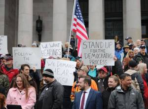 Washingtonians from all over the state gathered on the north steps at the capitol in Olympia, for a rally planned only a week in advance. Protesters displayed signs that read We want hearings, and Follow the constitution. Photo by Aspen Anderson