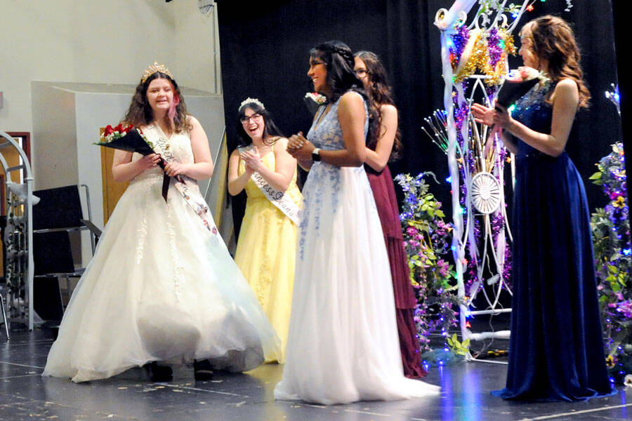 Lauren Rawley, the 2023 May Festival Queen, prepares to give a bouquet of roses to her successor, the newly selected May Festival Queen Anna Hernandez, while 2023 Princess Deana Lohness and the 2024 Princesses, Jayden Glover and Sierra Buckmiller look on. Gary DeVon/staff photos