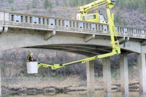 The Washington State Department of Transportation inspects the SR97 bridge over the Okanogan River south of Oroville in April of 2021. Gary De Von/GT File Photo